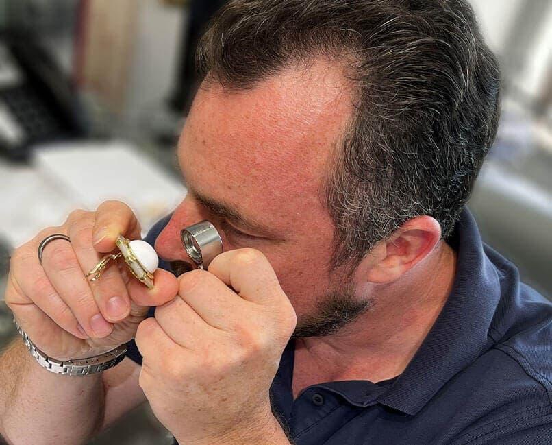 man examining a diamond